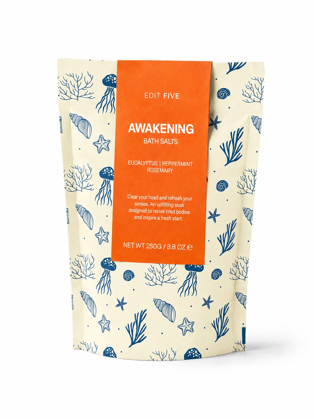 A stand-up pouch of Edit Five Awakening Bath Salts, featuring a cream-colored background with blue sea-themed illustrations like jellyfish, starfish, and coral, and a prominent orange label on the front. Handmade aromatherapy bath salts featuring an equal blend of Epsom salts and mineral-rich Dead Sea salts with pure eucalyptus, peppermint and rosemary essential oils.