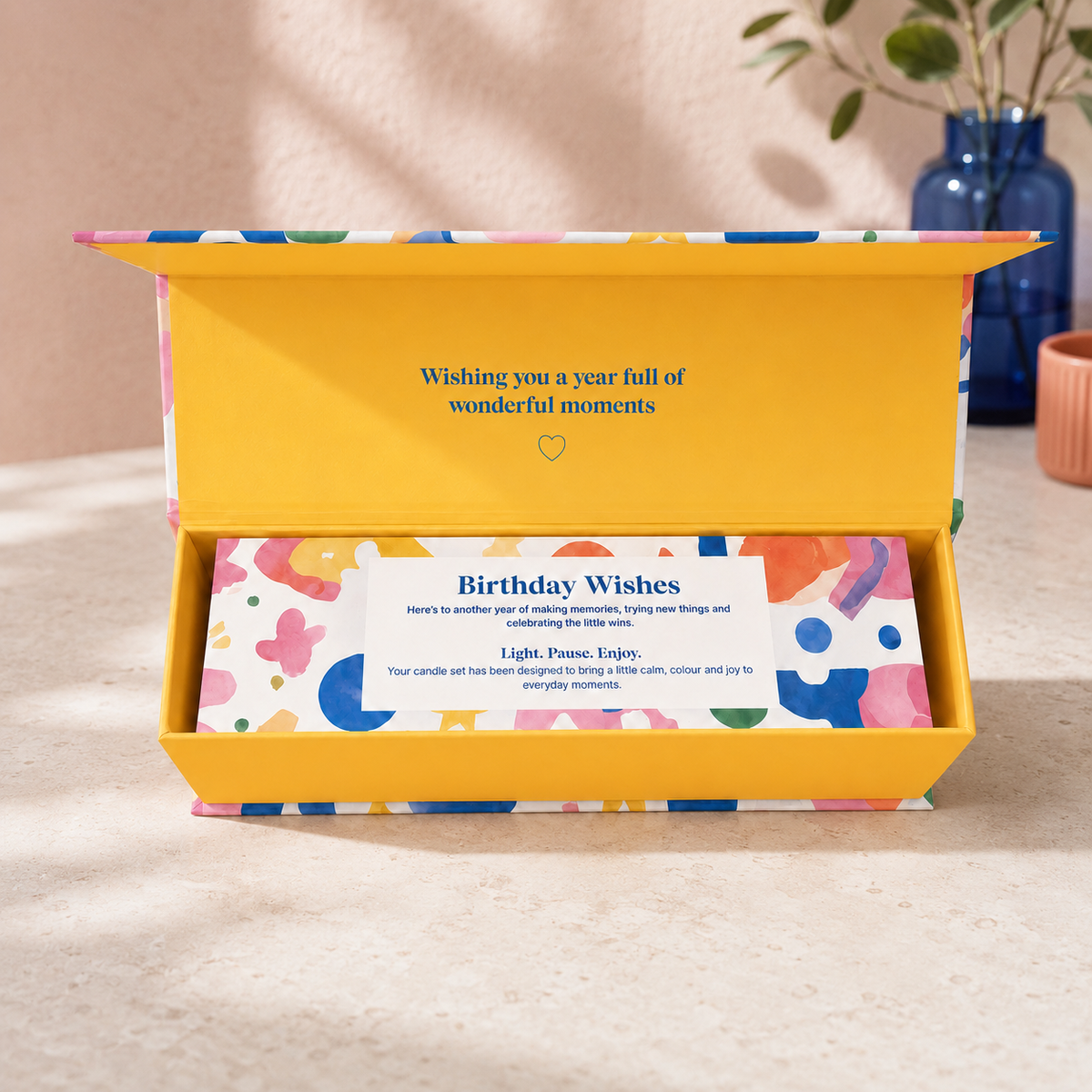 Colourful three-candle birthday gift set featuring coffee and vanilla, bergamot and warm woods, and tobacco, cedarwood and amber fragrances in elegant gold candle tins.