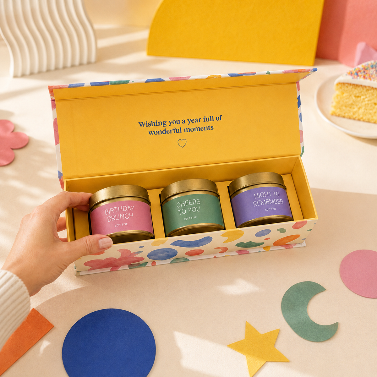 Luxury birthday gift for her featuring three scented candles in decorative gold tins, beautifully presented in a bold, colourful magnetic keepsake box designed in the UK.