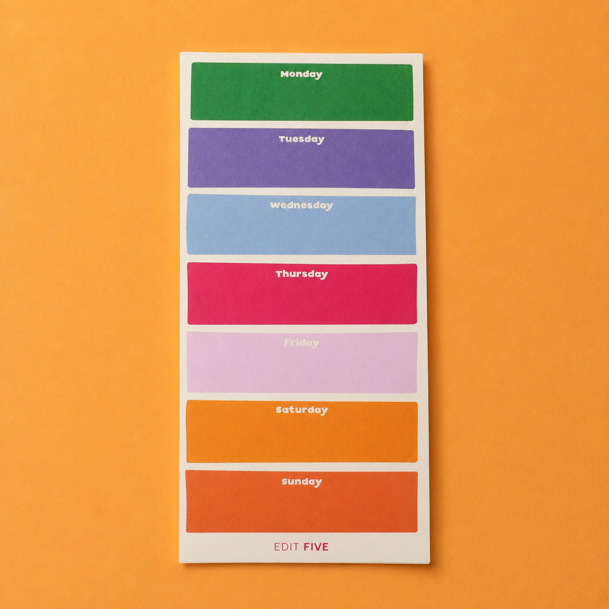 A weekly planner sticker sheet from Edit Five featuring colored blocks for Monday through Sunday with white text labels, displayed on a solid orange background. Colourful Monday–Sunday weekly planner notepad with a bright rainbow layout, daily planning sections and 50 tear-off sheets for appointments, meal plans, work tasks and family schedules.